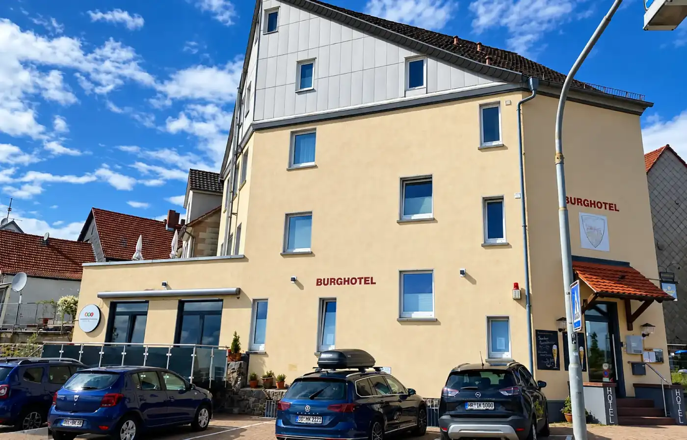 Burghotel Homberg exterior under a bright blue sky